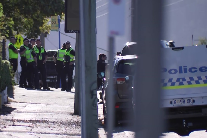 Police at the scene of a pedestrian fatality in city street.