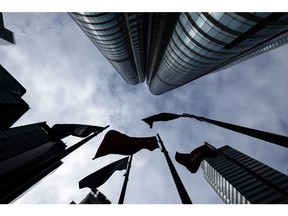 Flags outside the Exchange Square Complex, which houses the Hong Kong Stock Exchange, in Hong Kong, China, on Tuesday, Jan. 23, 2024. Asian stocks advanced, led by Hong Kong, on news that Chinese authorities are considering a rescue package to stem an extended market slump.