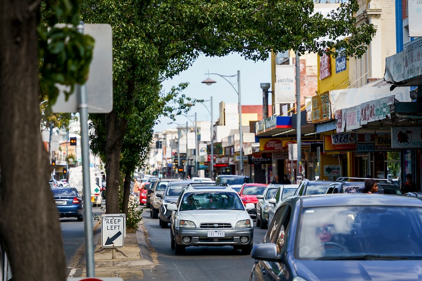 Cars driving down High St Preston.