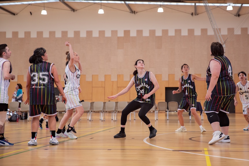 QSA basketball players look skyward, as the competition begins