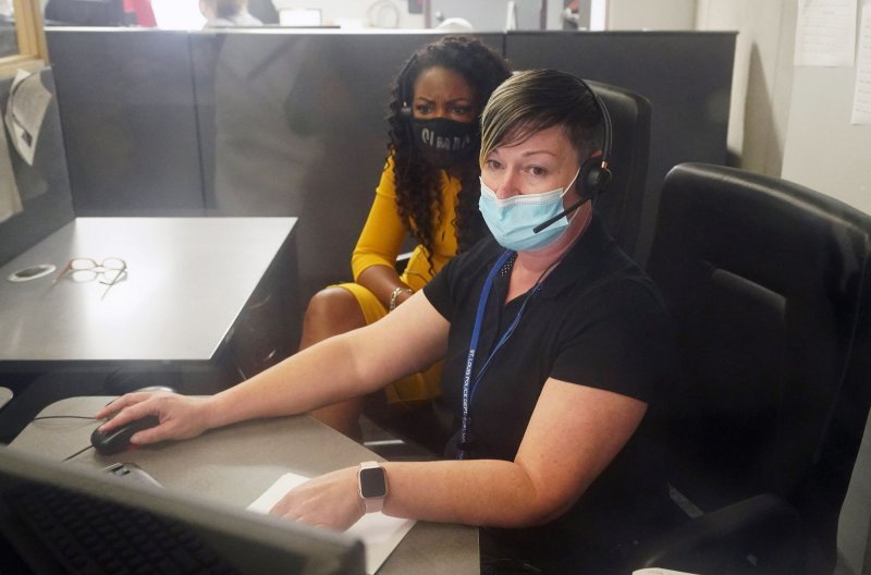 St. Louis Mayor Tishaura Jones listens to a domestic violence call as police dispatcher Kelli Williams speaks to the caller, during a tour of the St. Louis 9-1-1 Dispatch Center in St. Louis on Thursday, August 26, 2021. 911 services in four states were disrupted in an outage on Thursday. File Photo by Bill Greenblatt/UPI