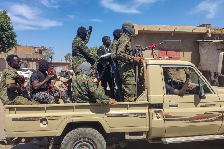 Supporters of the Sudanese armed popular resistance, which backs the army, ride on trucks in Gedaref in eastern Sudan