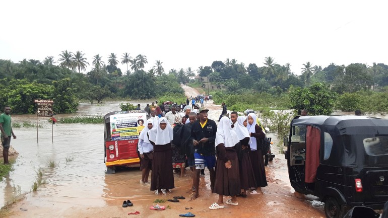 Schoolchildren stranded on a damaged River Zingiziwa bridge in Dar Esalaam, Tanzania