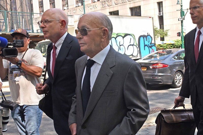 British Billionaire Joe Lewis (C) has been fined $5 million by a federal court in Manhattan but escaped being sent to prison after pleading guilty to orchestrating what U.S. prosecutors said was a "brazen" insider trading scheme that saw recipients of his stock tips make millions of dollars. File Photo by Louis Lanzano/UPI