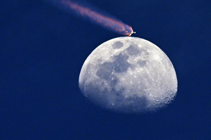 A SpaceX Falcon 9 rocket carrying 23 Starlink satellites flies past the moon from Launch Complex 40 at the Cape Canaveral Space Force Station in Florida on Thursday. Photo by Joe Marino/UPI