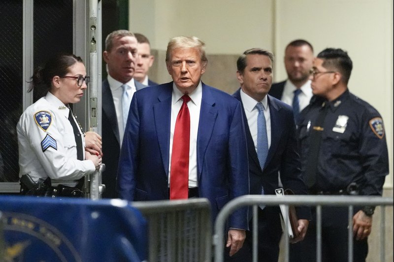 Former President Donald Trump speaks from the hallway outside a courtroom where he attended a hearing in his criminal case on charges stemming from hush money paid to an adult film actress in New York City on March 25. Pool Photo by Mary Altaffer/UPI