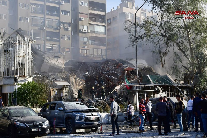 Emergency and security personnel inspect the rubble at the site of strikes that hit a building annexed to the Iranian embassy in Syria's capital Damascus on April 1. Photo by Syrian Arab News Agency/ UPI