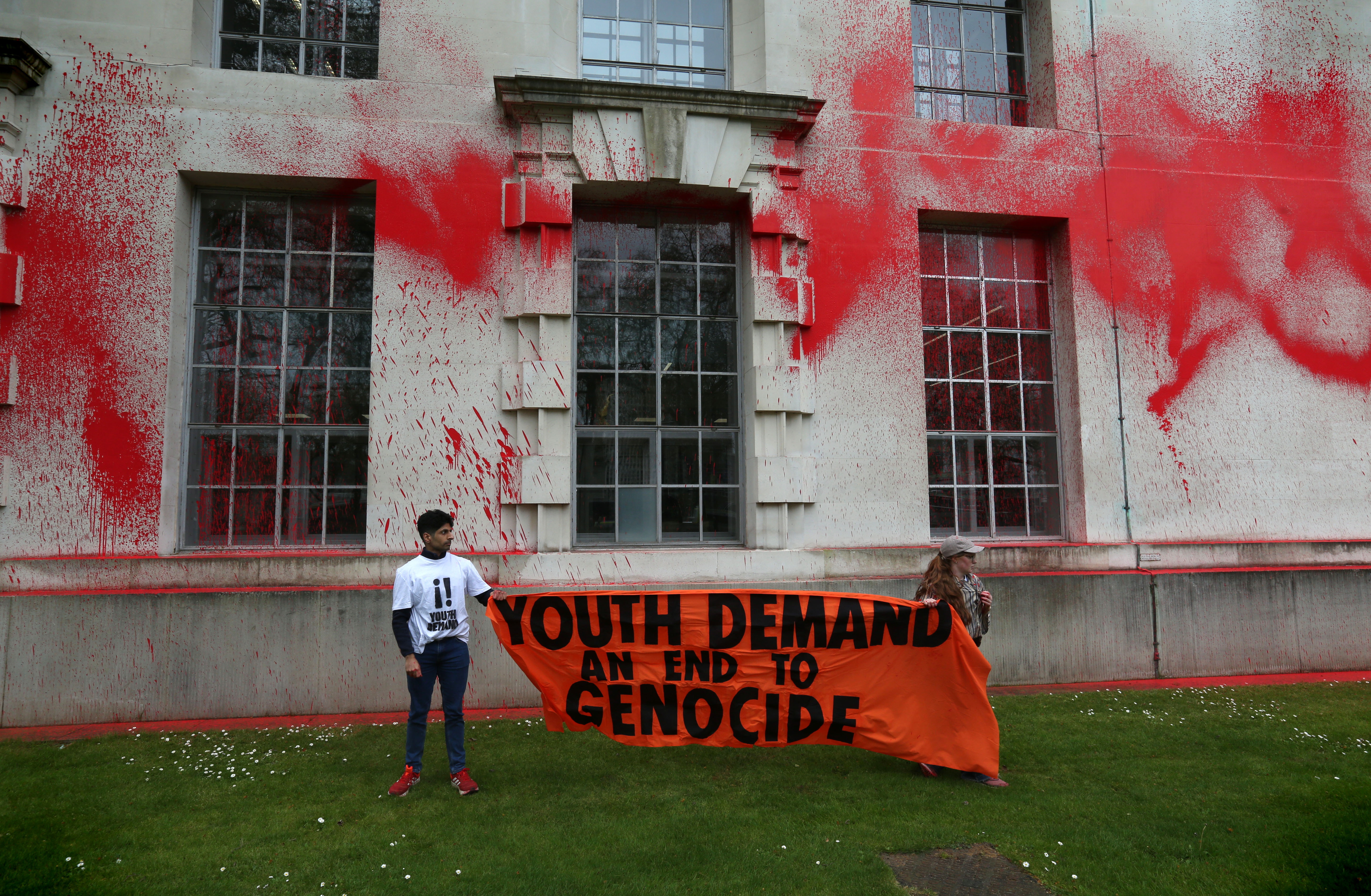 Protesters attack an MOD building with red paint