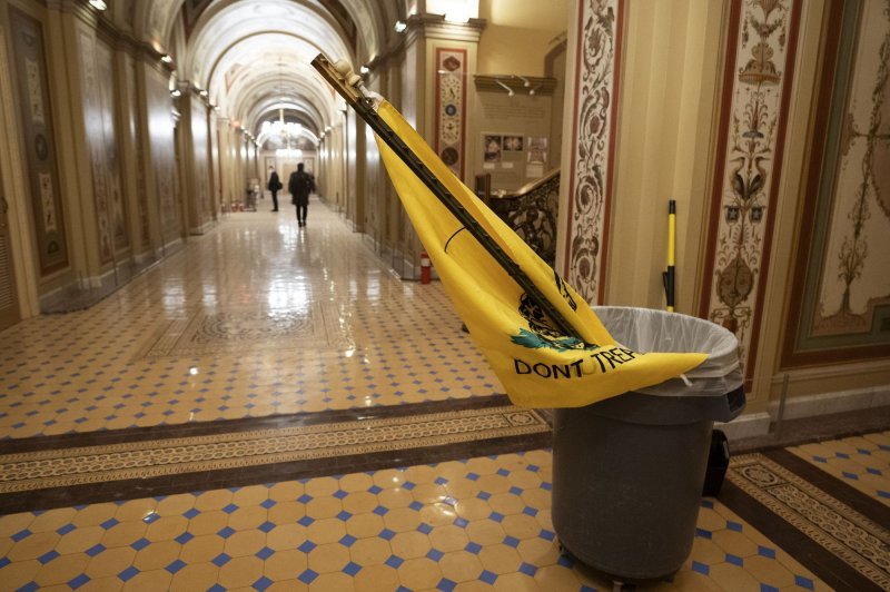 A "Don't Tread on Me Flag" favored by MAGA supporters is seen in a trash can after a pro-Trump mob stormed and occupied the U.S. Capitol Building in clash with U.S. Capitol Police in Washington in January 2021. The U.S. Attorney's Office said more than 1,387 people have been arrested and nearly 500 have been charged with assaulting or impeding law enforcement related to Jan. 6. File Photo by Kevin Dietsch/UPI