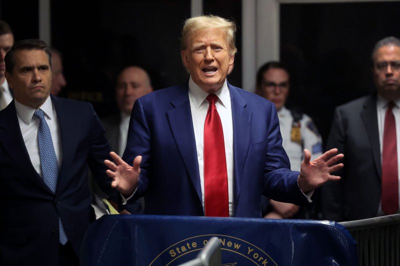 Former President Donald Trump speaks from the hallway outside a courtroom where he attended a hearing in his criminal case on charges stemming from hush money paid to an adult film actress in New York City on March 25. Pool Photo by Spencer Platt/UPI