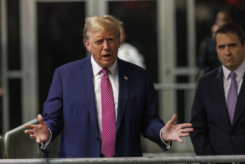 Former President Donald Trump speaks to the media as he leaves the courtroom after the final jurors were selected in his criminal trial at Manhattan Criminal Court in New York on Friday. Opening statements will begin on Monday on charges Trump allegedly falsified business records to cover up a sex scandal during the 2016 campaign. Pool Photo by Sarah Yenesel/UPI