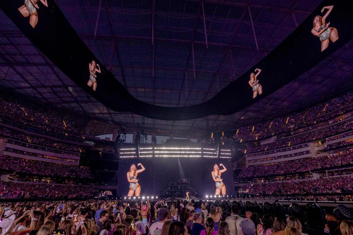 Taylor Swift is seen on massive video screens during her Eras Tour at SoFi Stadium in Inglewood 