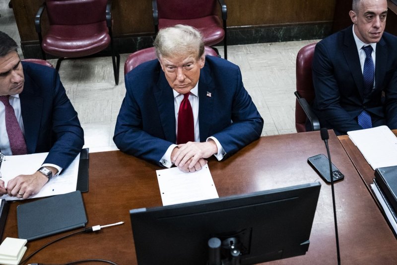 Former President Donald Trump sits in Manhattan criminal court with his legal team ahead of the start of jury selection in his historic hush-money criminal trial on Monday. Shares in his company, Trump Media, plunged by 18% in Nasdaq trading. Pool photo by Jabin Botsford/UPI