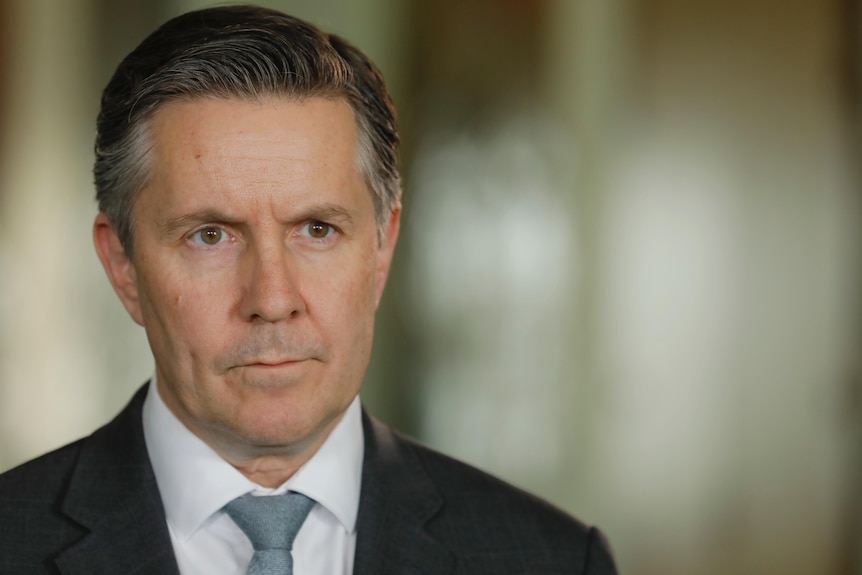 A close shot of Health Minister Mark Butler's face, looking serious.