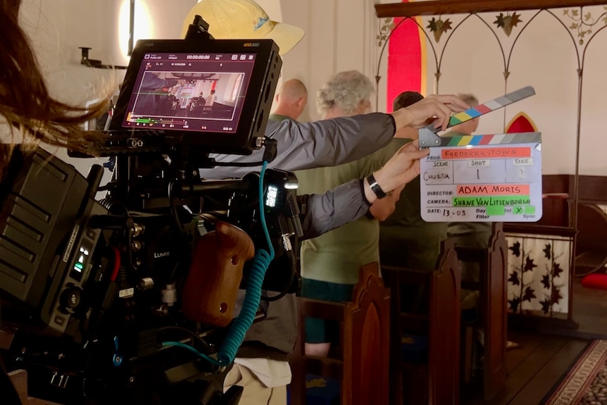 Take shot start man holding film information in front of camera before filming scene