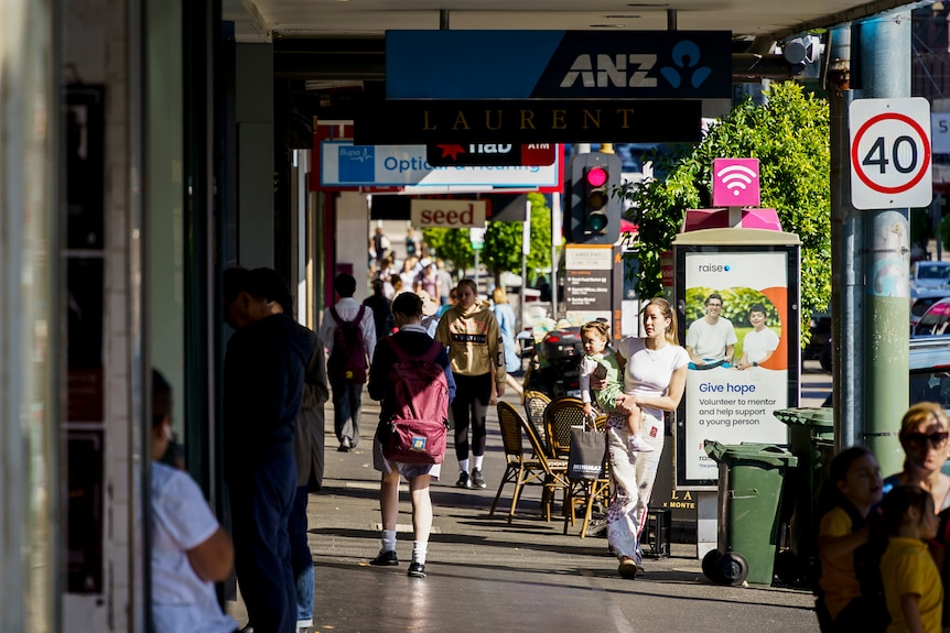 Pedestrians walking down a street in Camberwell.