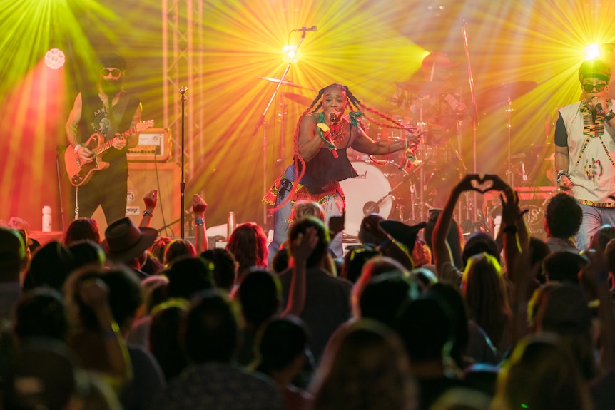 Woman on stage and crowd in front of her