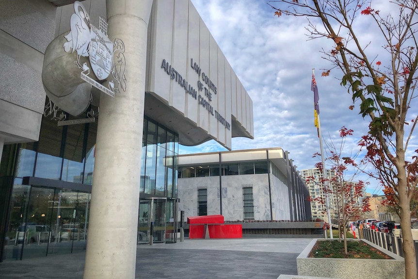 The exterior of the court, showing the sign and the crest.