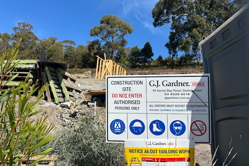 A sign in front of a construction site.