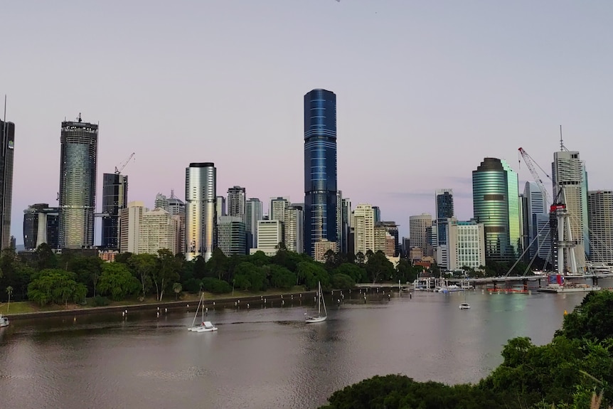 A purple hue fills the sky over Brisbane CBD at sunrise