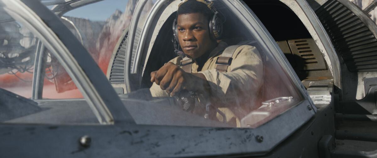 A fighter pilot sits in a spaceship while the ship is on land