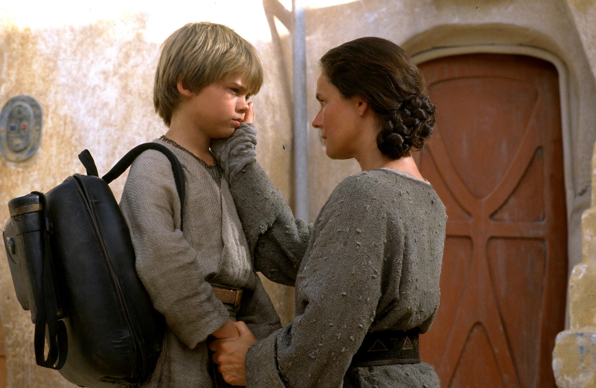 A boy and his mother say goodbye.