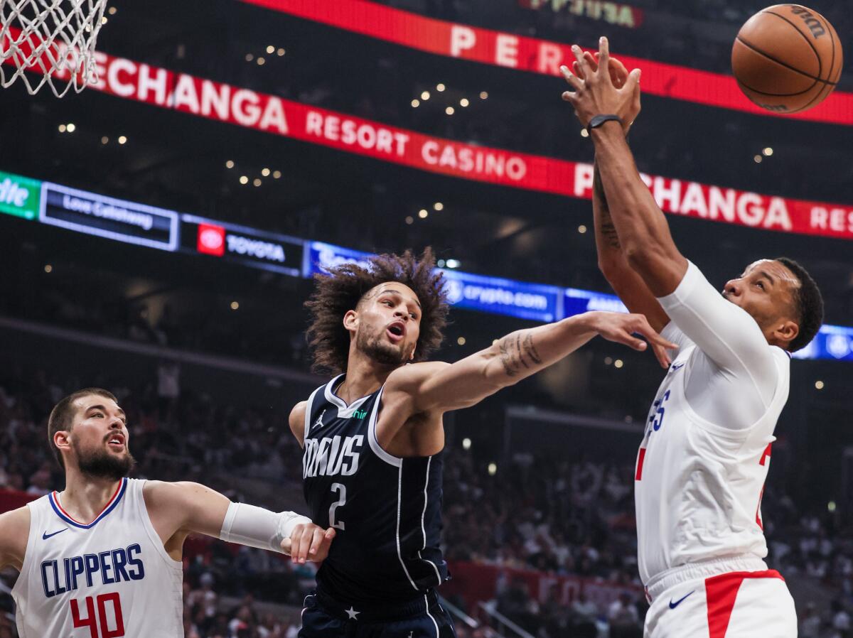 Dallas Mavericks center Dereck Lively II tips a rebound away from Clippers guard Norman Powell 