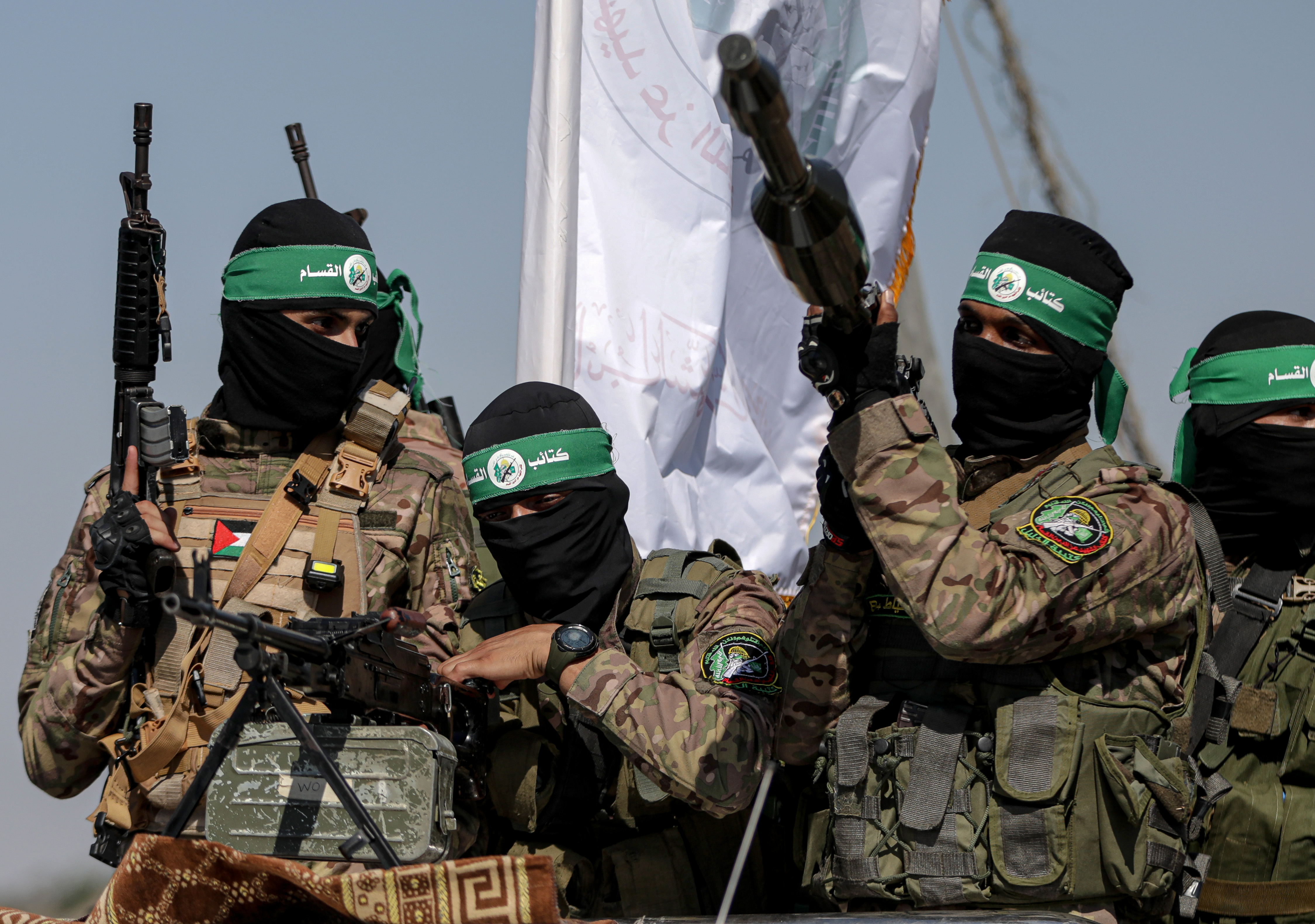 Hamas fighters are seen on the back of a truck during a military parade near the border with Israel in the central Gaza Strip