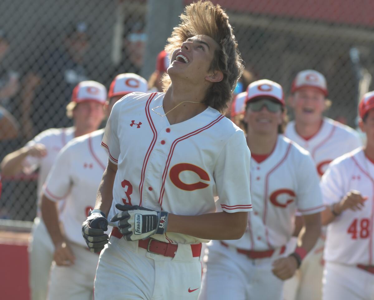 Billy Carlson celebrates with a smile after his walk-off home run lifts Corona to a 1-0 win over El Dorado.