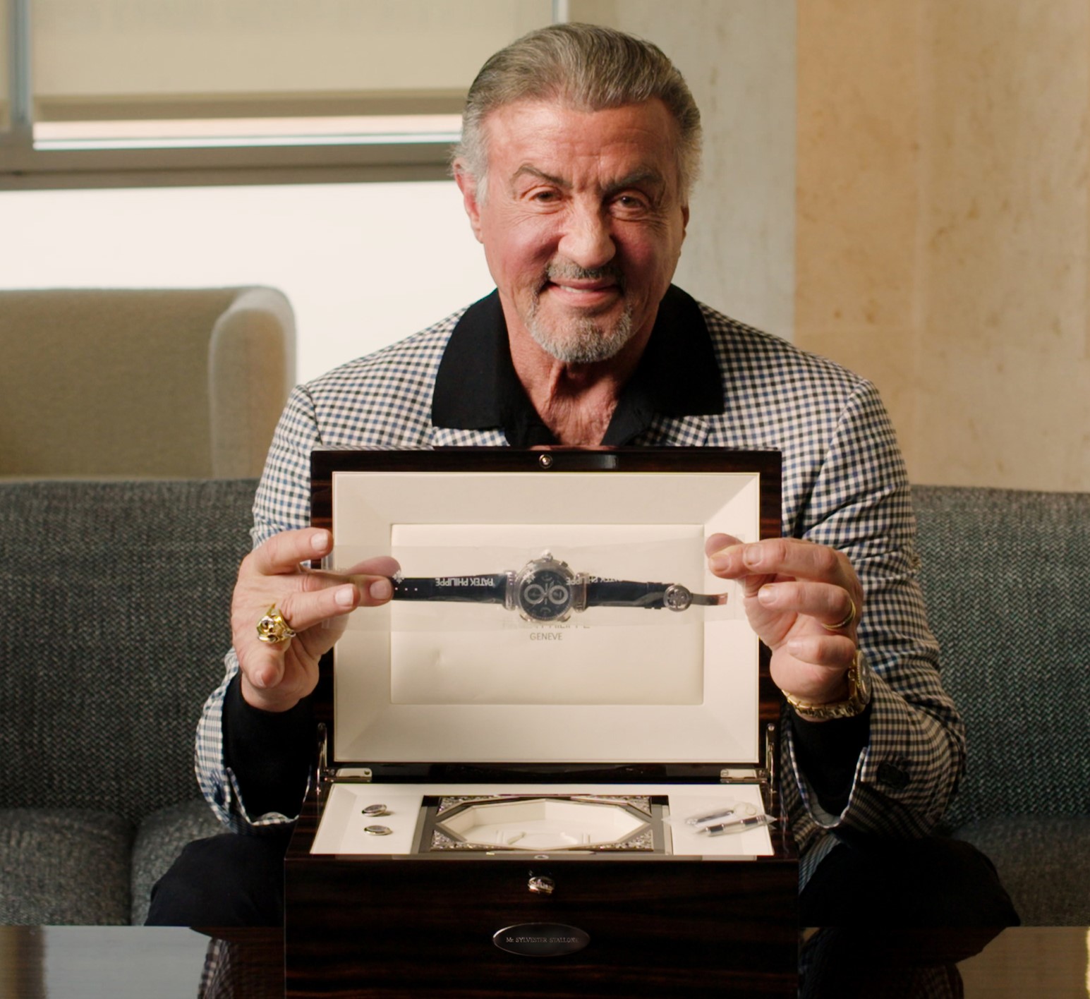 Stallone, seen here with the Patek Philippe Grandmaster Chime, says it is 'bittersweet' the watches are being sold