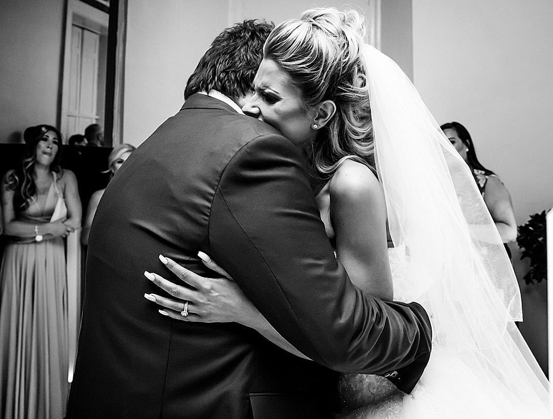 Sophie and Alan hugging on her wedding day