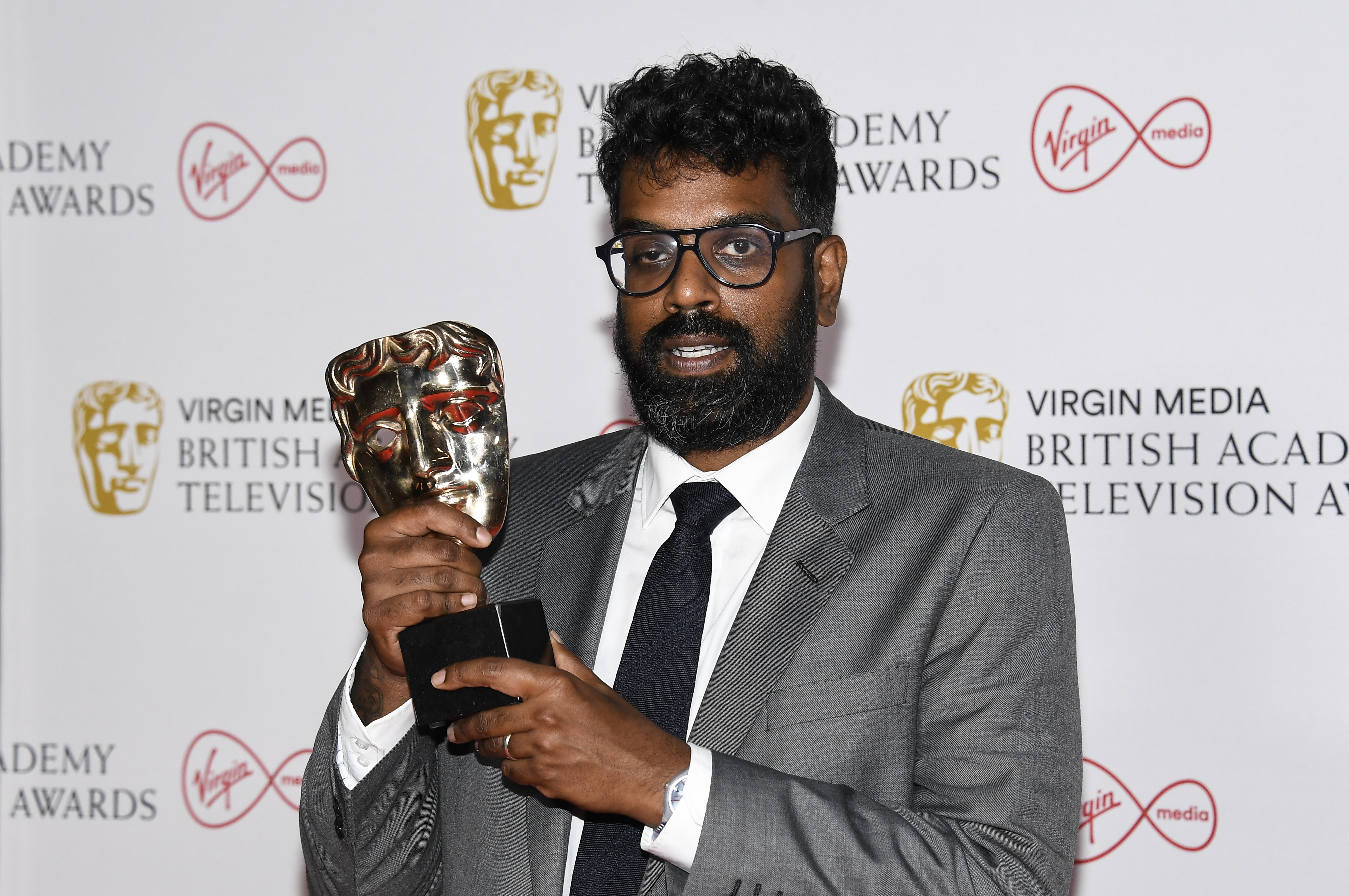 Romesh Ranganathan posing with his Bafta