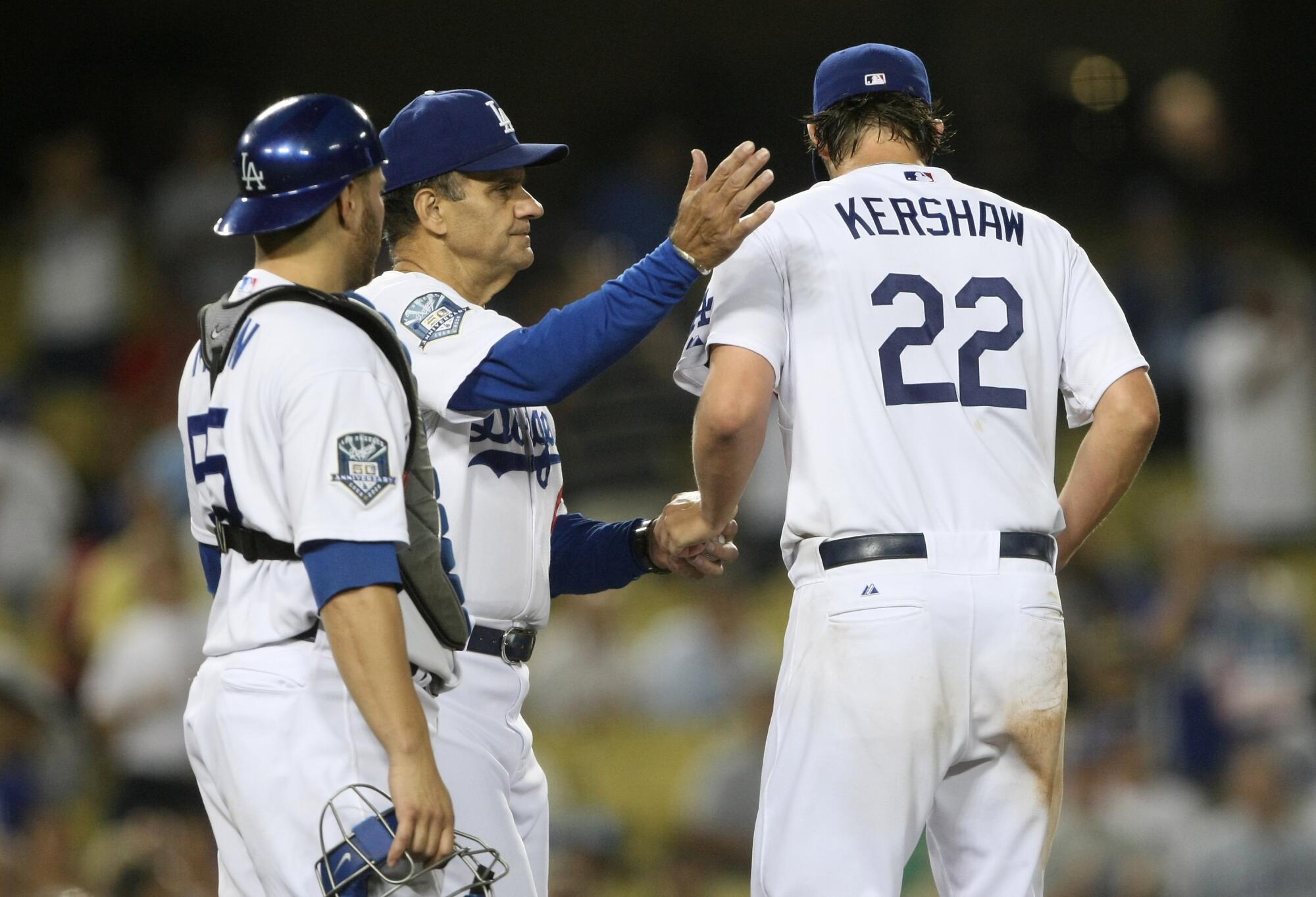 Dodgers manager Joe Torre pats starting pitcher Clayton Kershaw on the back as he removes him from a 2009 game 