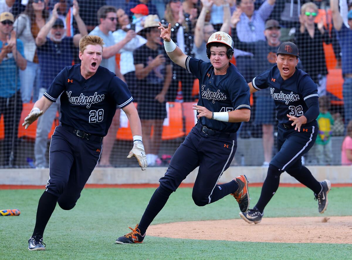 Trent Grindlinger (left), Freddie Angiuli and Phillip Kang celebrate walk-off double for Huntington Beach.