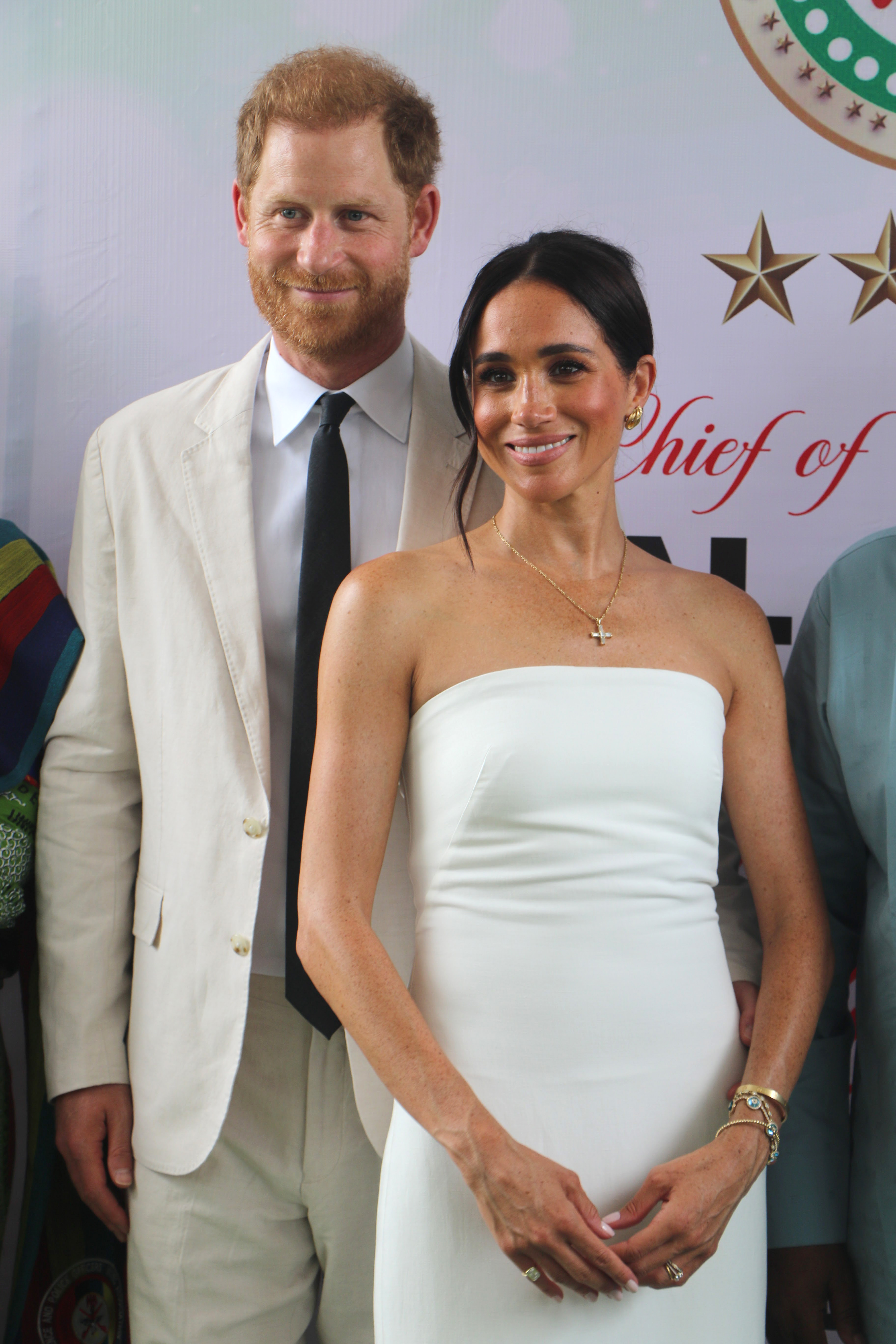 Harry and Meghan pose for a photo as they attend the programme held in the Armed Forces Complex in Abuj