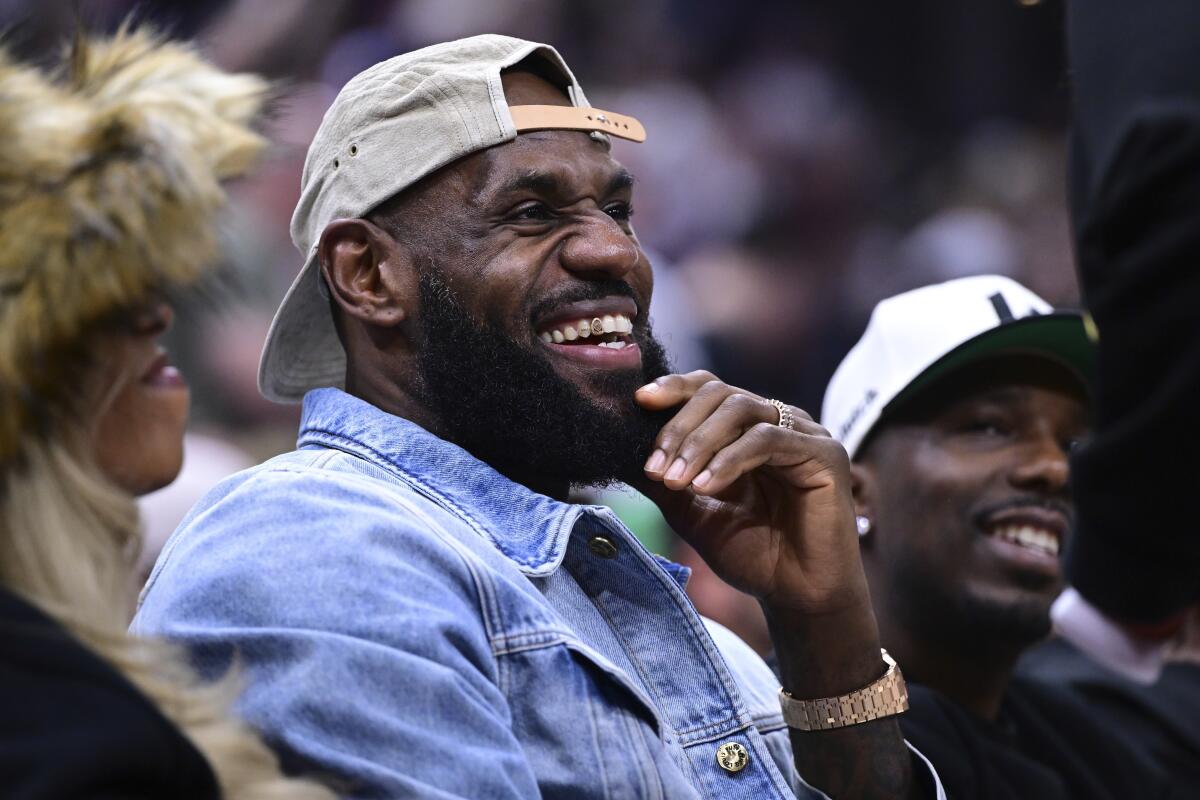 Lakers forward LeBron James smiles during a game between the Cleveland Cavaliers and Boston Celtics Monday