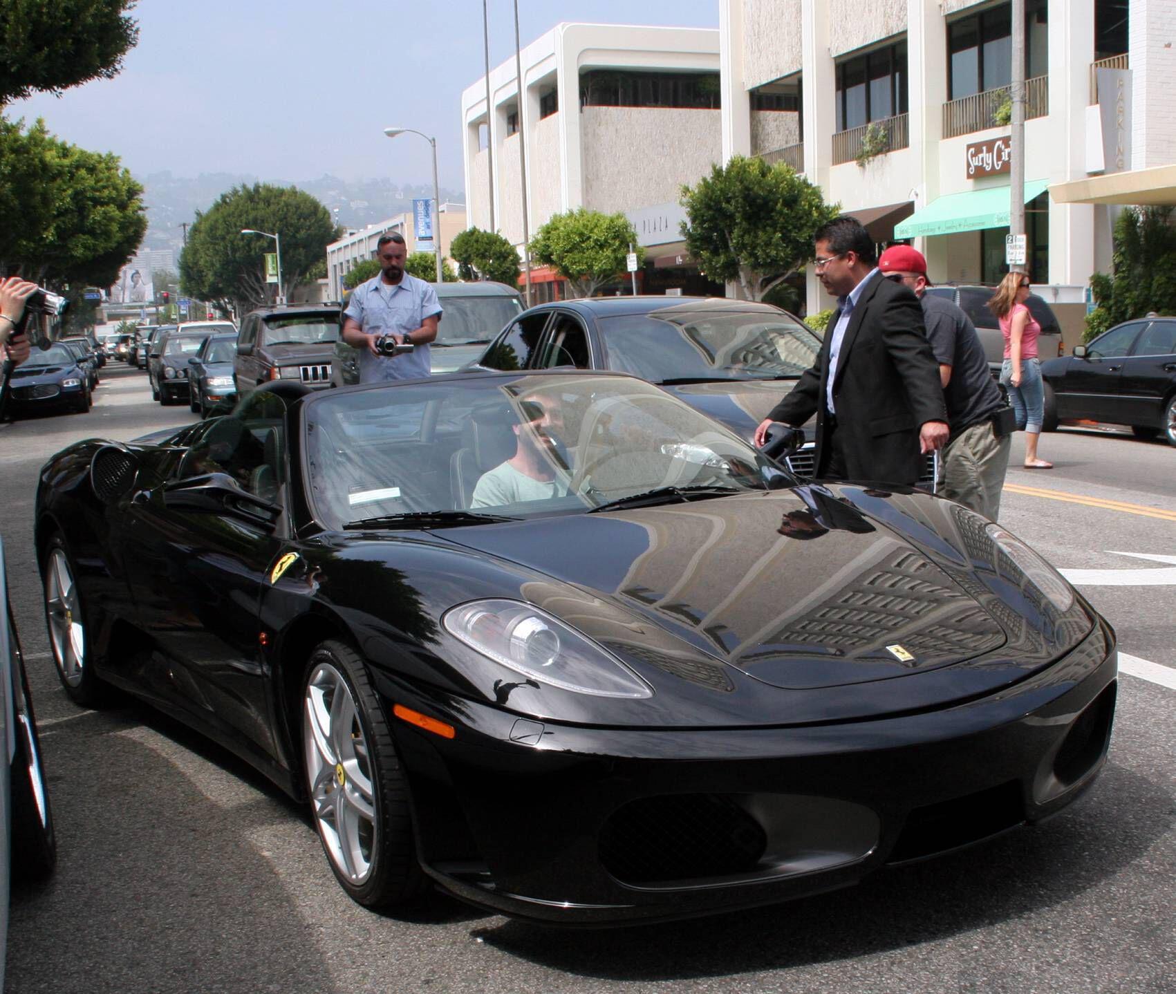 Cowell driving a Ferrari