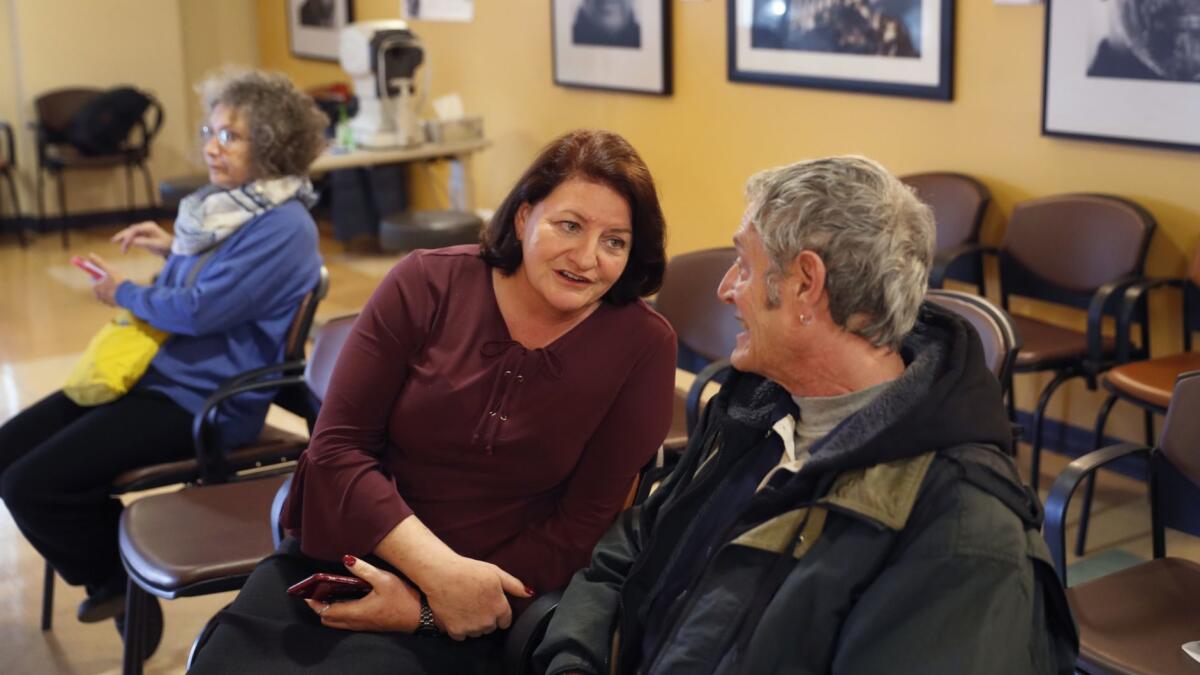State Sen. Toni Atkins speaks with Rick Siebert of San Diego, who was getting new glasses during a VSP vision-care event at Gary & Mary West Senior Dental Center in San Diego.