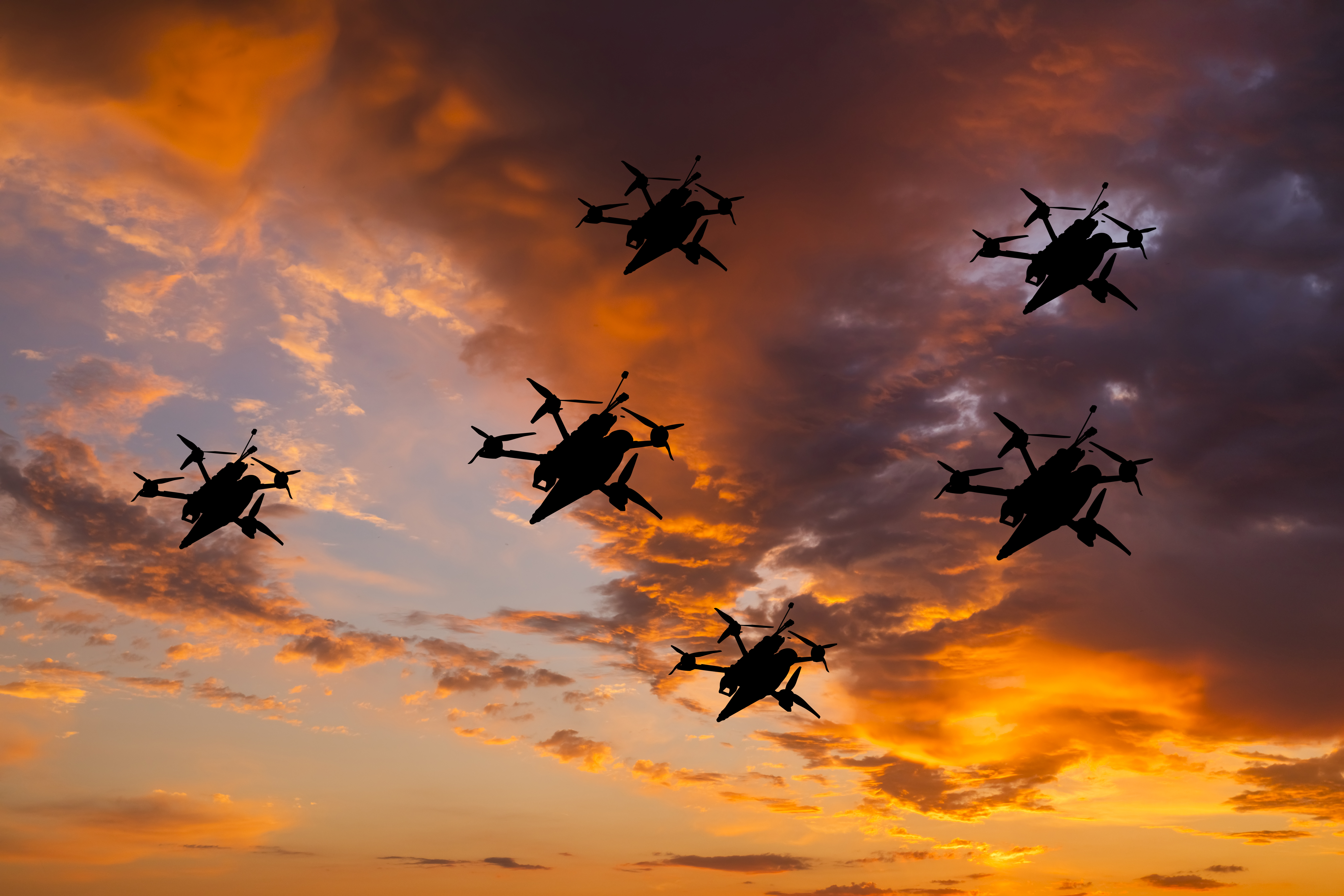 A swarm of FPV kamikaze drones flies above the battlefield - searching for enemy targets and destroying heavy Russian infrastructure