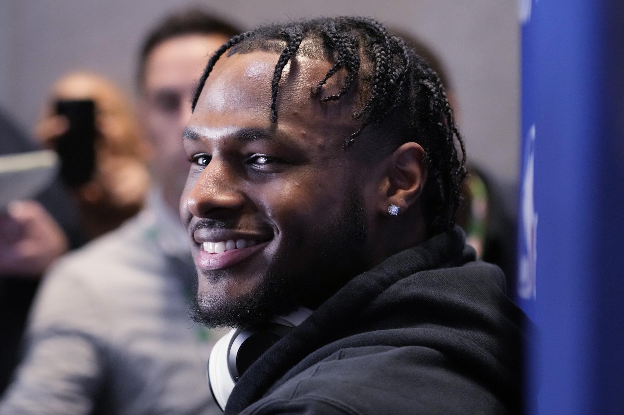 Bronny James smiles as he looks toward a reporter asking him a question during his media session Tuesday.