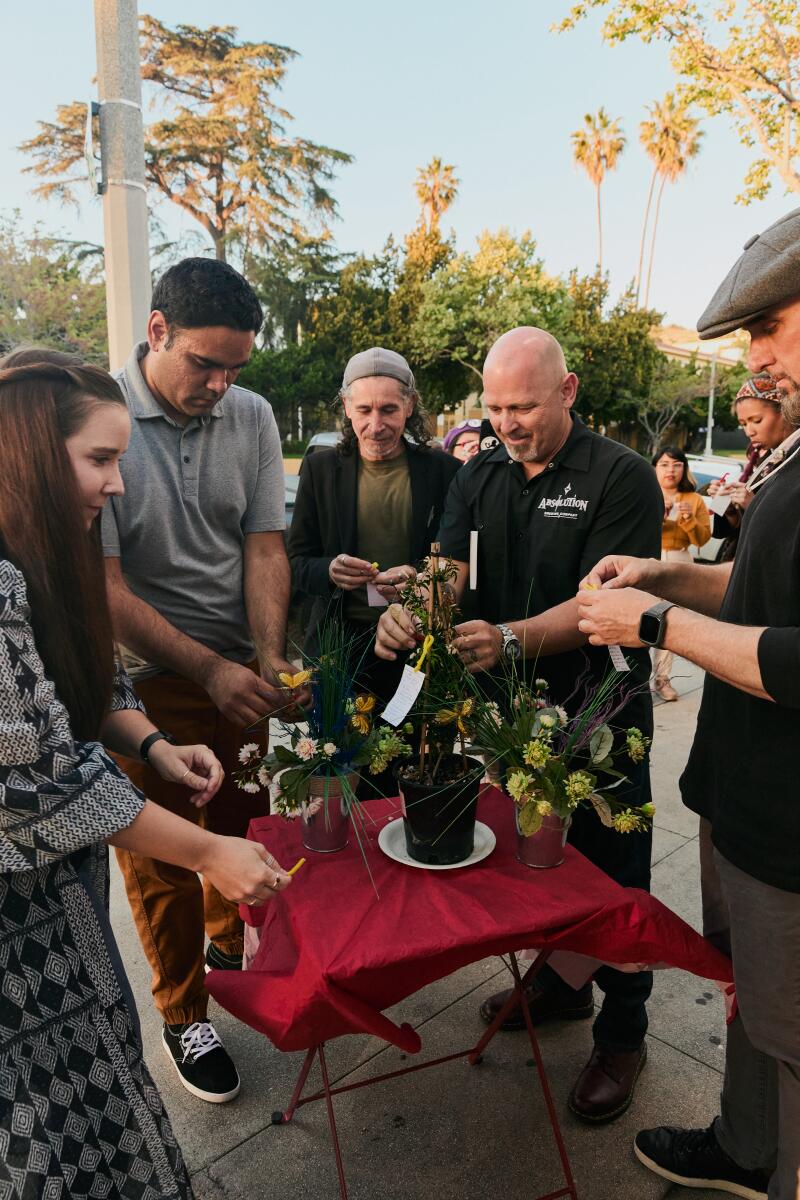 Attendees place their poems on plants outside the Libros bookshop.