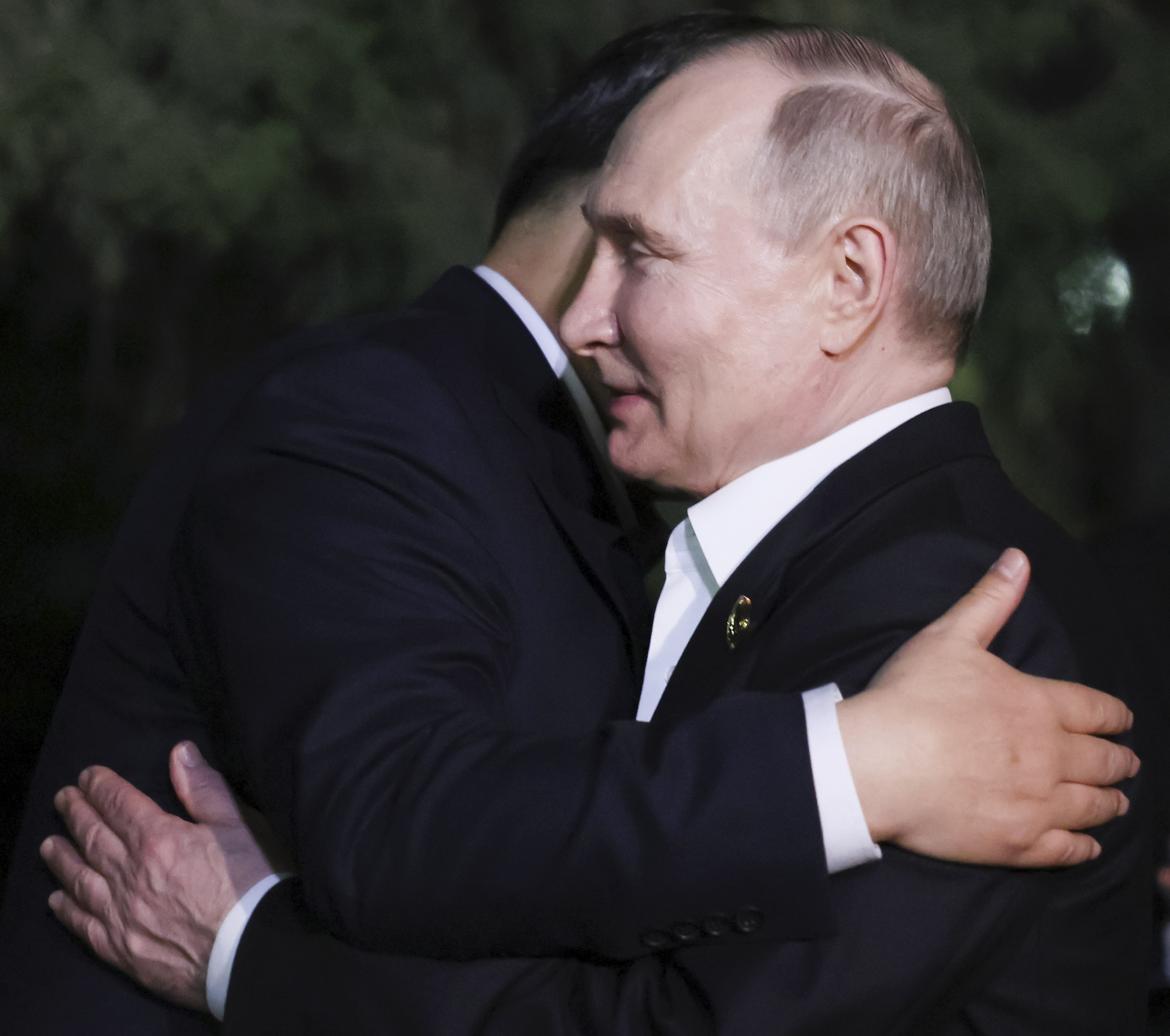 The bizarre moment Putin and Xi hugged not once, but twice, after a day spent strolling through a compound and sharing tea and snacks.