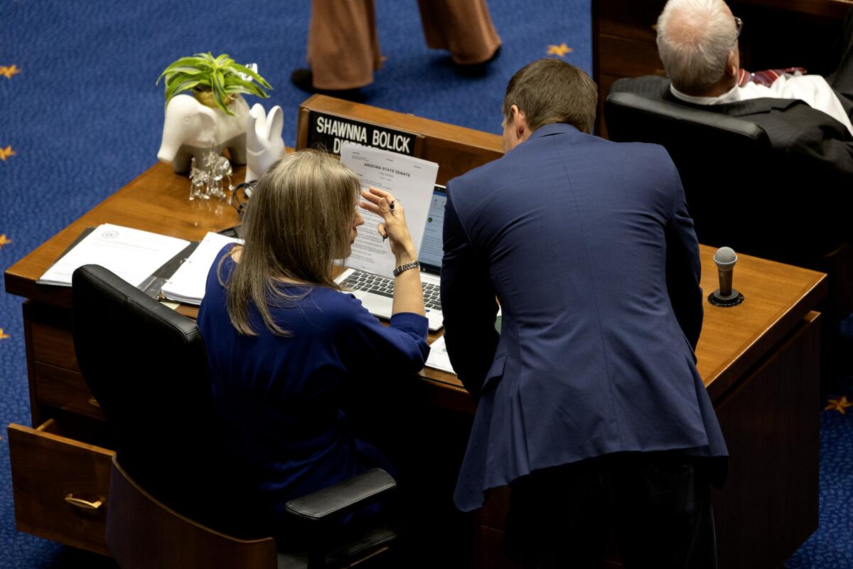Arizona Sen. Shawnna Bolick confers with a colleague in the senate chambers