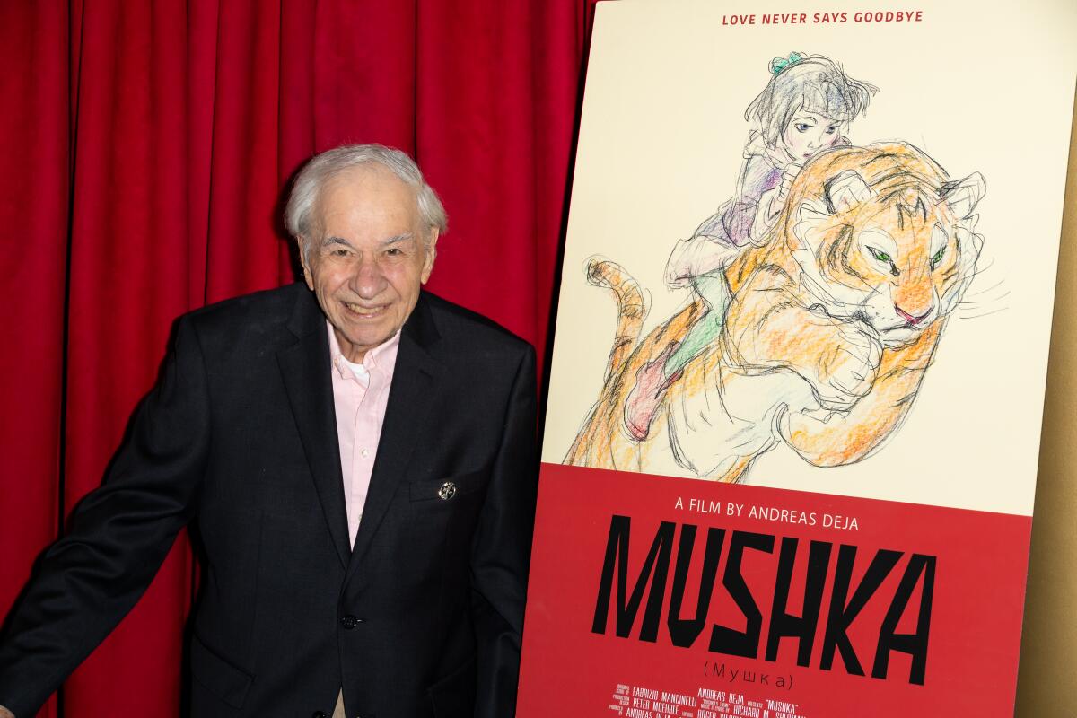 Richard M. Sherman with a poster for "Mushka."