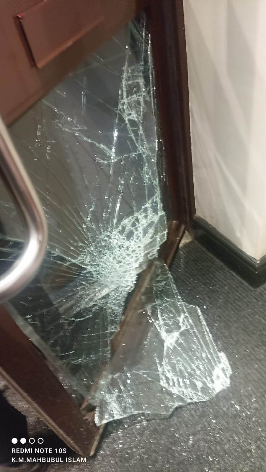 A smashed door and broken glass after the night of the attack