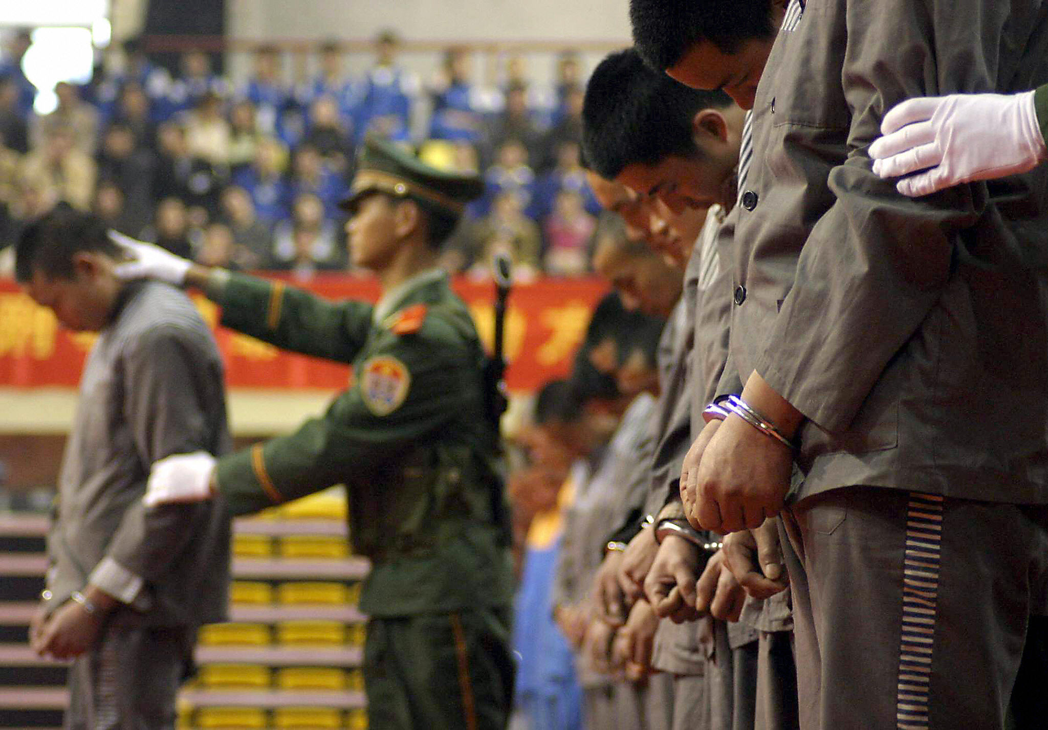 Chinese police show a group of convicts at a sentencing rally in the east Chinese city of Wenzhou where 11 prisoners were later executed for various crimes