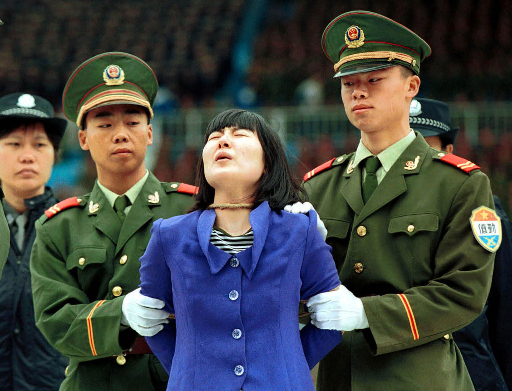 A woman convicted of murder shouts before she is executed in Guangzhou in 2001