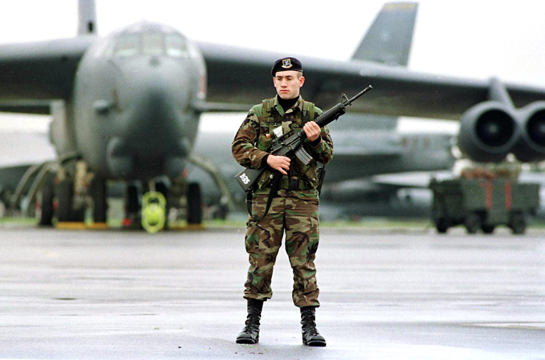 A US soldiers stands guard in front of a B-52 bomber at the Fairford RAF airbase