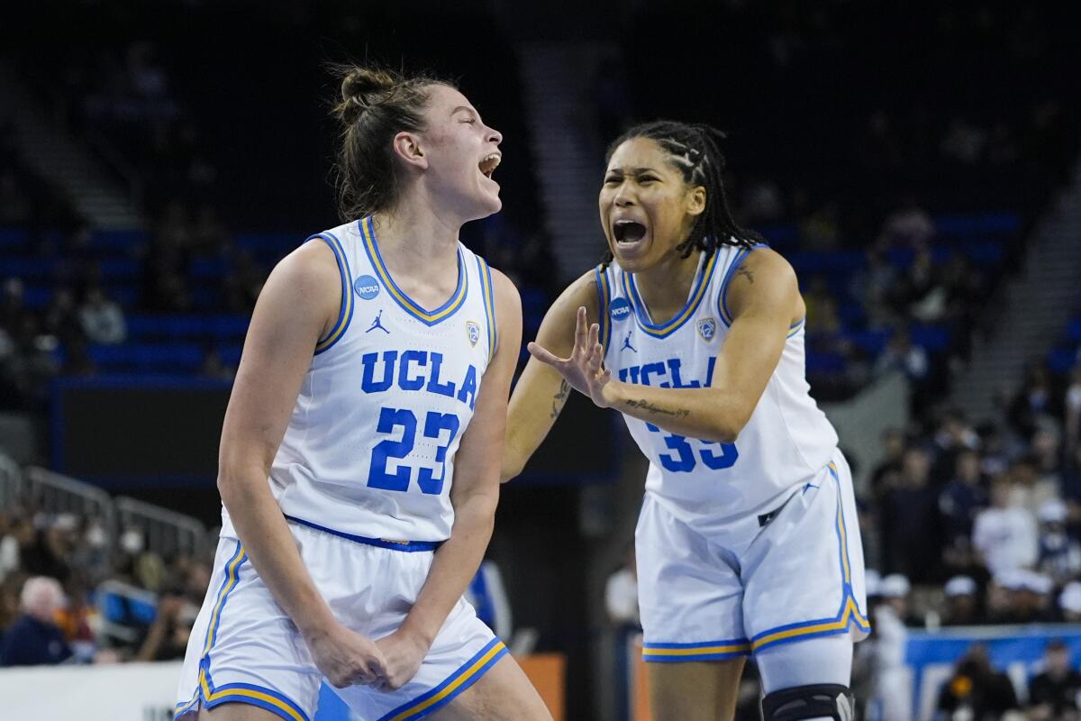UCLA's Gabriela Jaquez, left, celebrates with Camryn Brown after drawing a foul during a game against California Baptist.