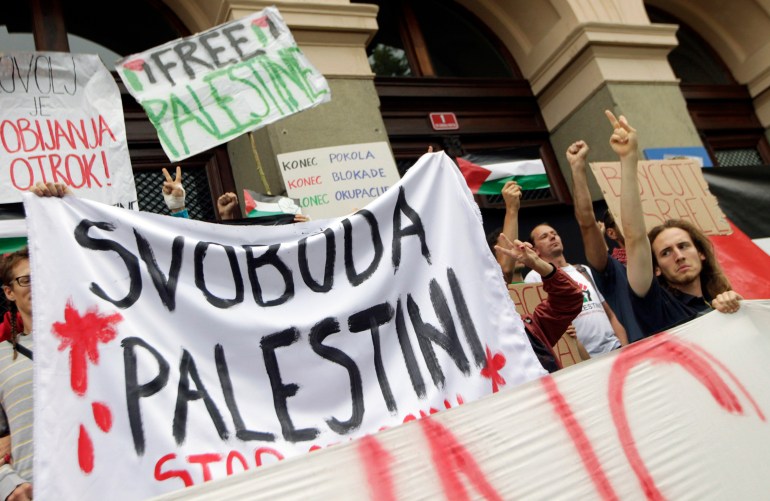 Protesters take part in a demonstration against violence in the Gaza strip, before the third qualifying round of the Champions league soccer match between Maribor and Maccabi Tel Aviv, in Maribor, July 30, 2014. The banner reads, "Freedom to Palestine". REUTERS/Srdjan Zivulovic (SLOVENIA - Tags: CIVIL UNREST SPORT SOCCER POLITICS)